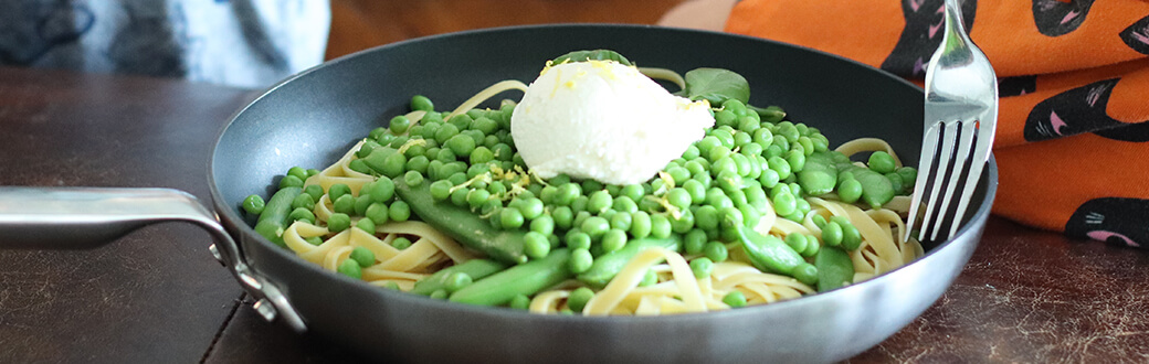 prepared summer fettuccine in a pan with a fork.