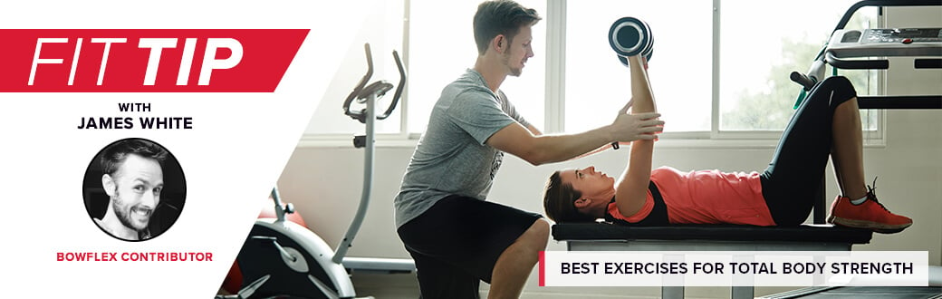 A trainer helping a person with a bench press.