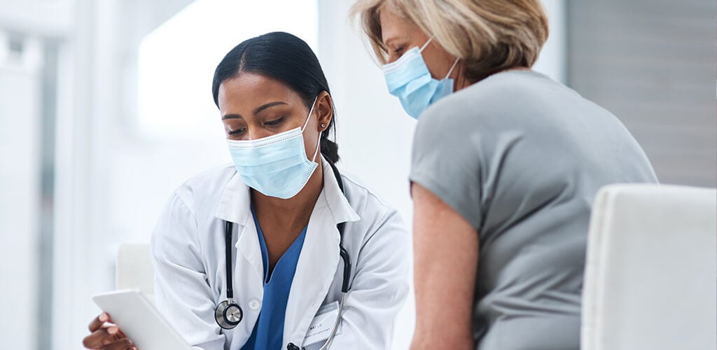 A doctor meeting with her patient.