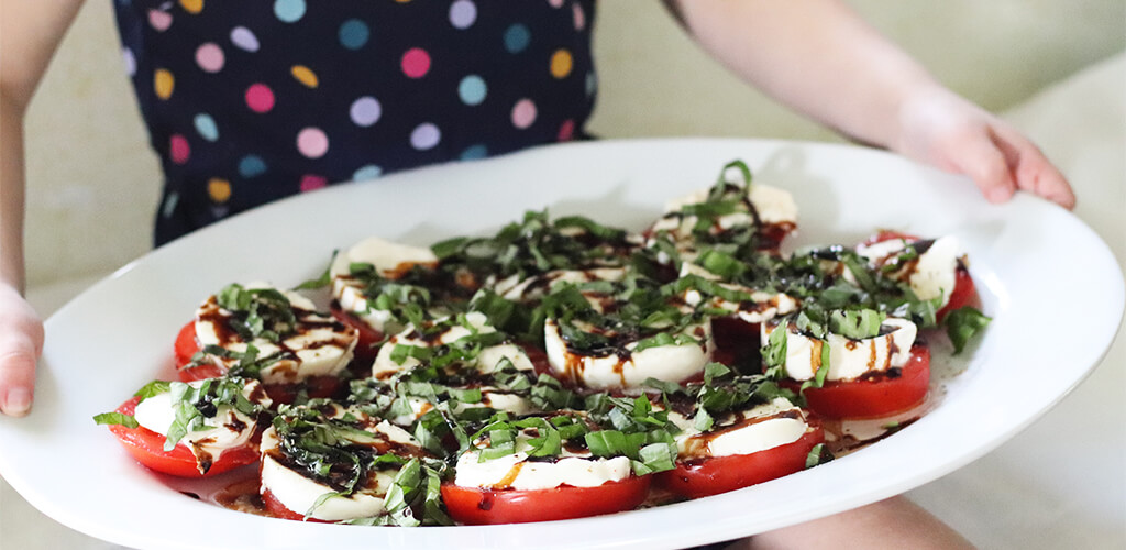 Caprese salad on a white plate.