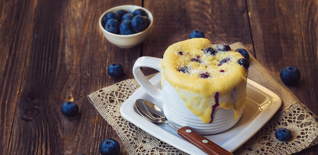 A mug muffin with blueberries.