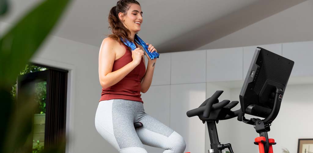 A woman working out in the morning on a VeloCore bike.
