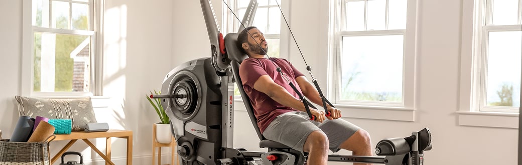 man working out on the bowflex revolution home gym