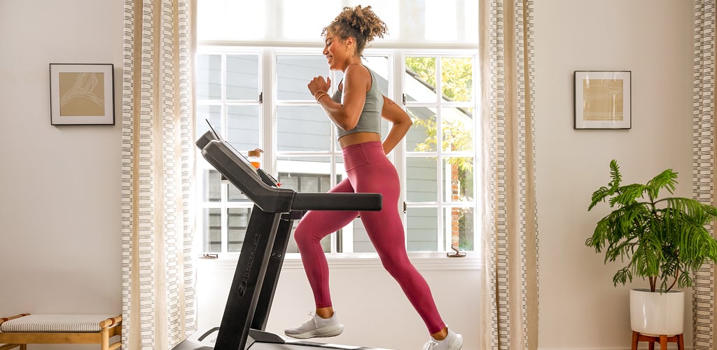 woman running on a bxt8j treadmill
