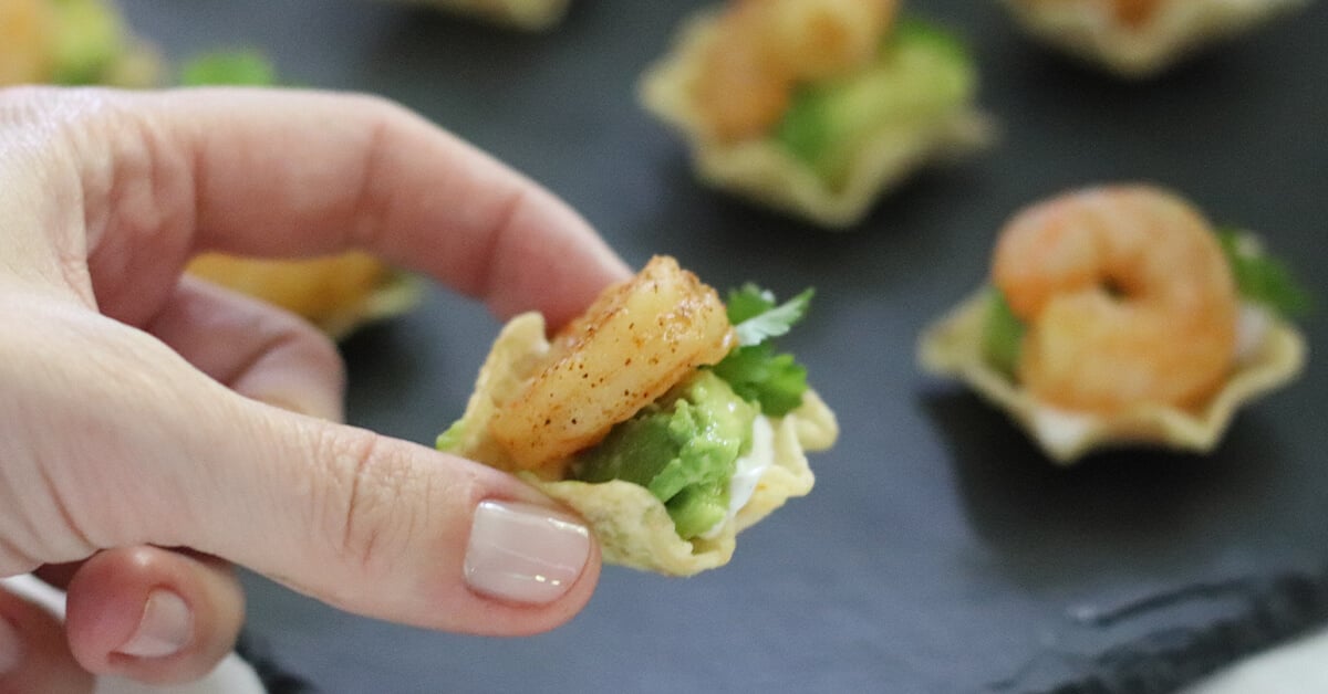 avocado, lime, and cilantro on a cutting board