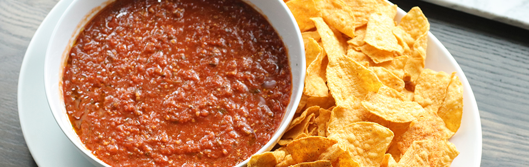 Bowl of salsa served next to corn chips