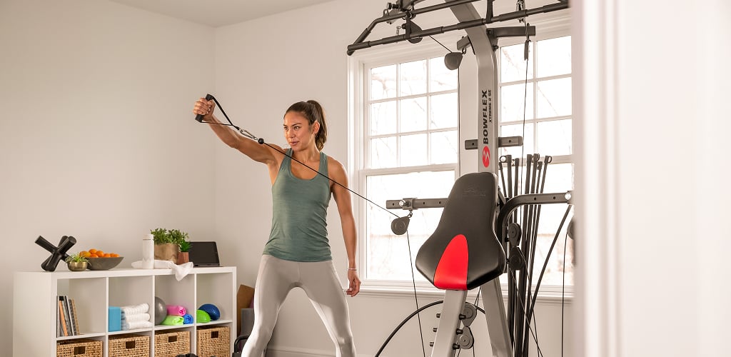 woman using xtreme 2 se home gym