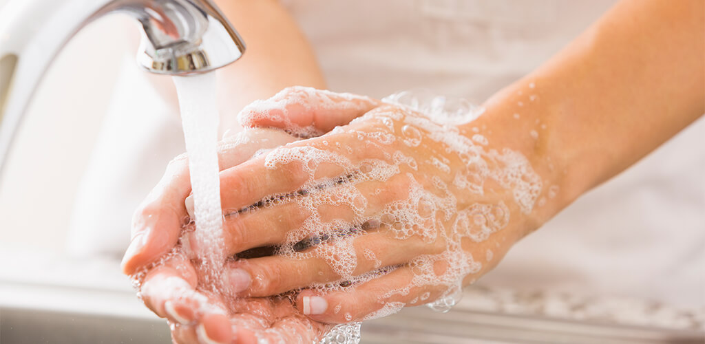 A person washing their hands.