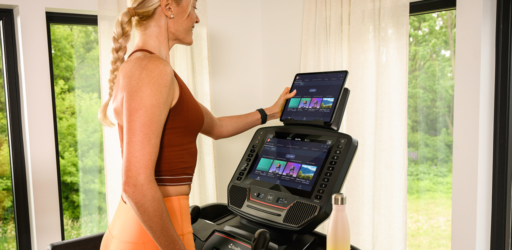 woman on a bowflex treadmill looking at the console