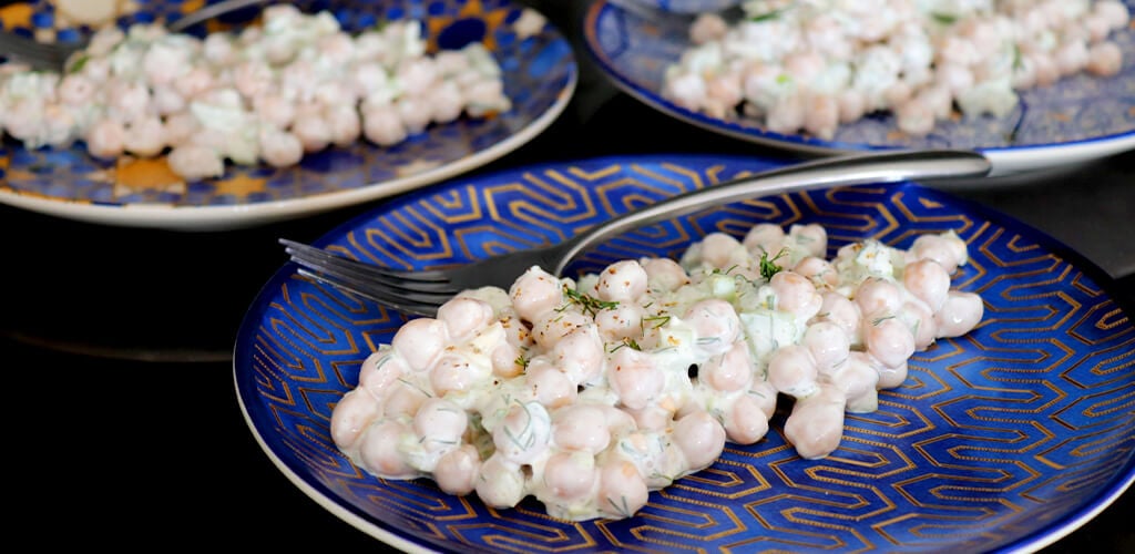 Three plates of garbanzo bean salad.