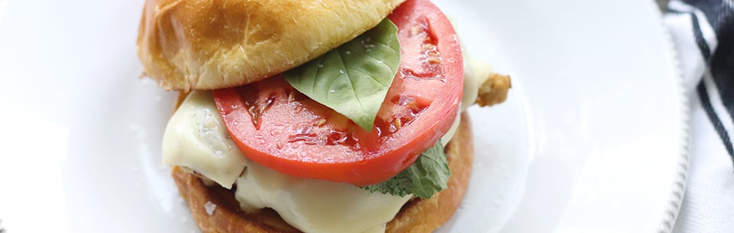 Ground chicken patty on brioche bun, plus cheese, lettuce, and tomato