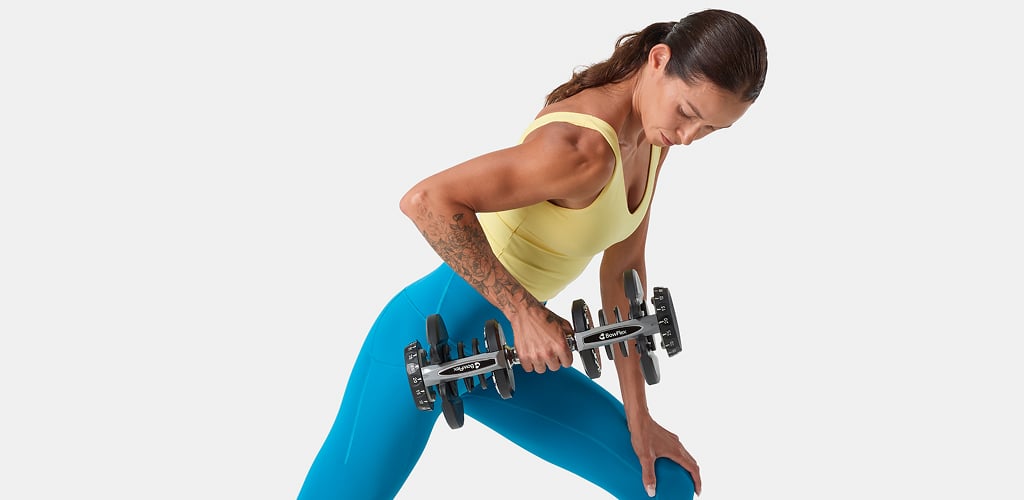 woman using selettech dumbbell