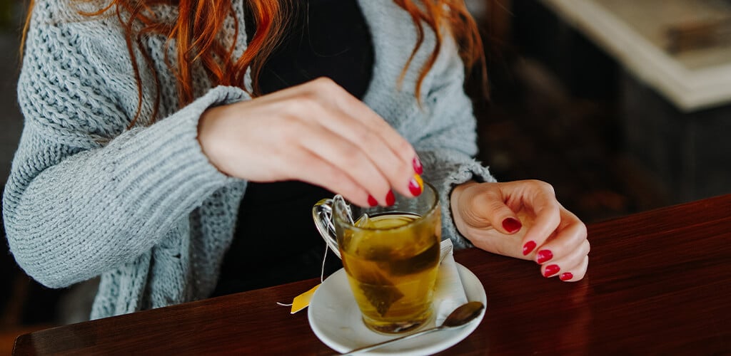 A woman drinking tea.