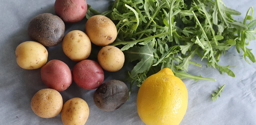 Potatoes, arugula, and a lemon.