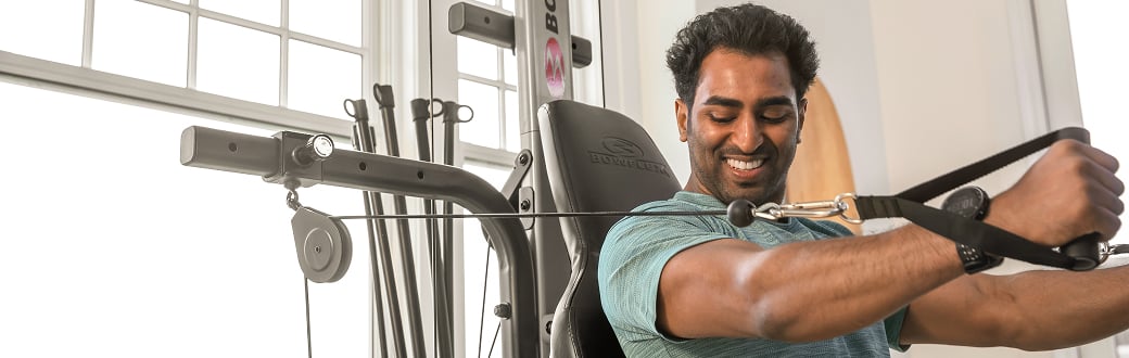man working out on a bowflex homegym