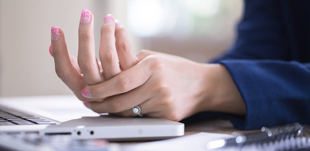 a person massaging their finger joints