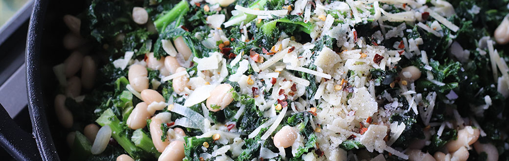 White beans and kale in a serving dish.