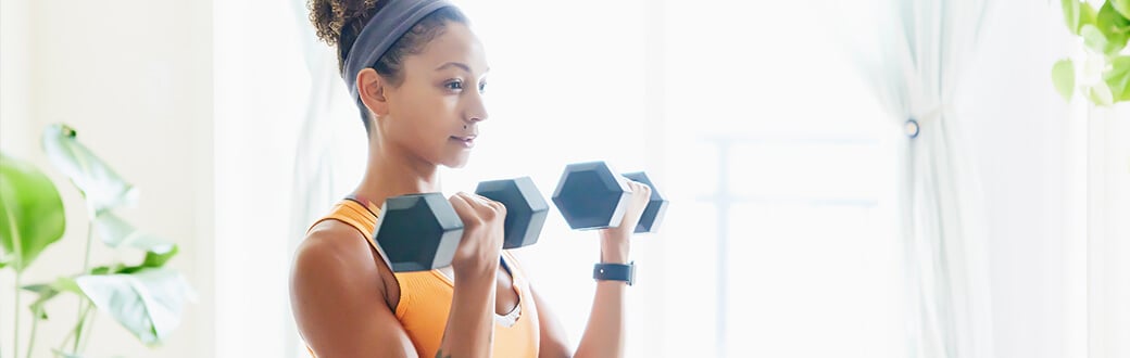 A woman working out with dumbbells.