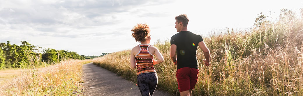 couple running on a trail outdoors