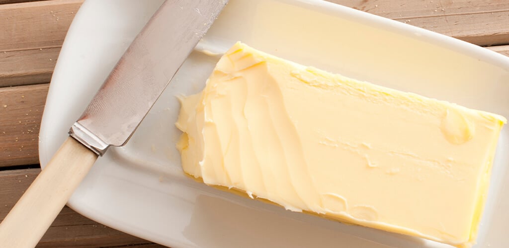 a stick of butter on a dish