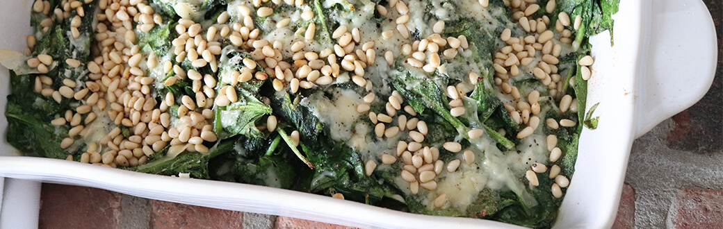Spinach bake in a white baking dish.