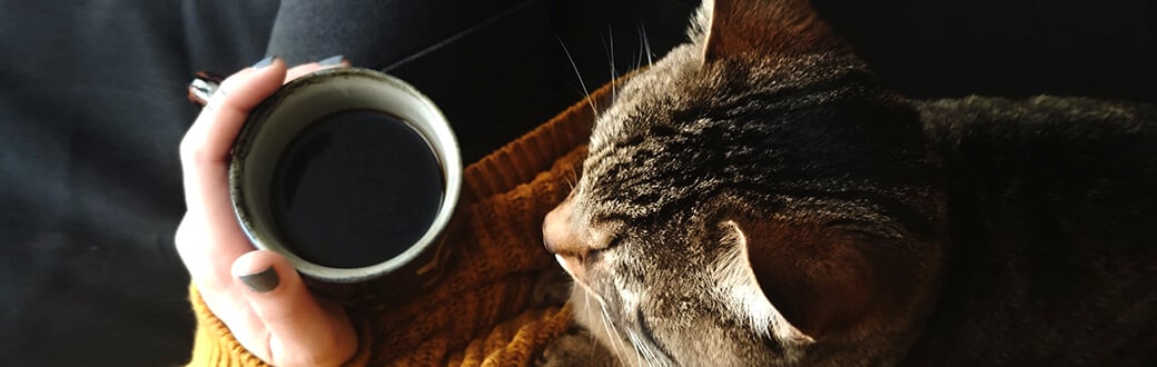 A person holding a cup of coffee.