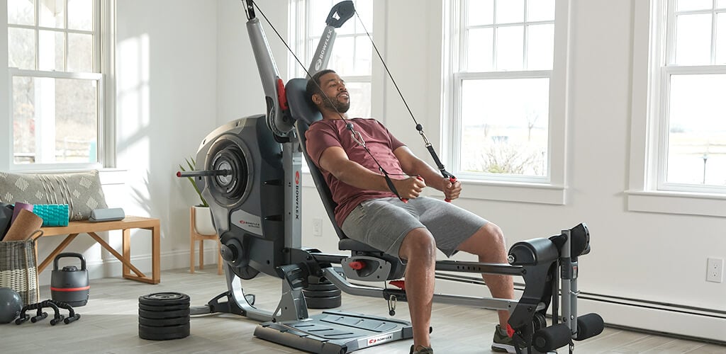 A man working out on a Revolution Home Gym.