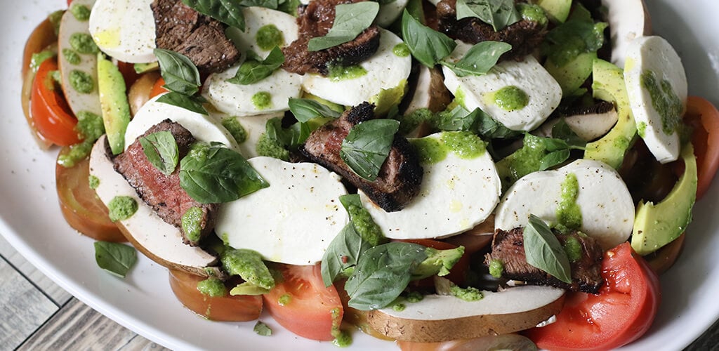 Steak salad on a serving plate.