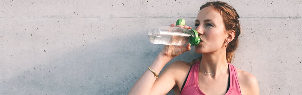 A woman drinking water.