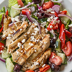 Greek marinated chicken over a greek salad.