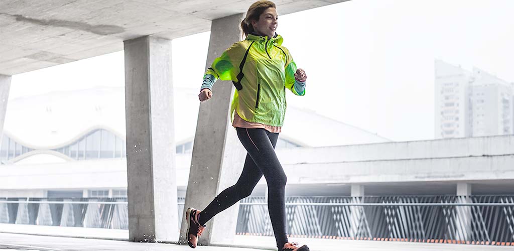 A woman running in the rain.