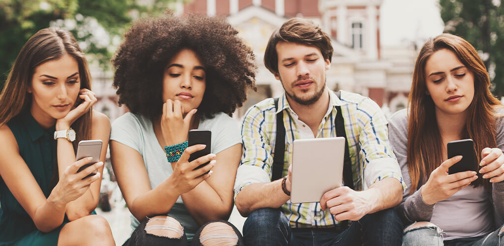Four people using mobile devices