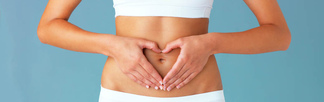 A woman with her hands on her stomach.