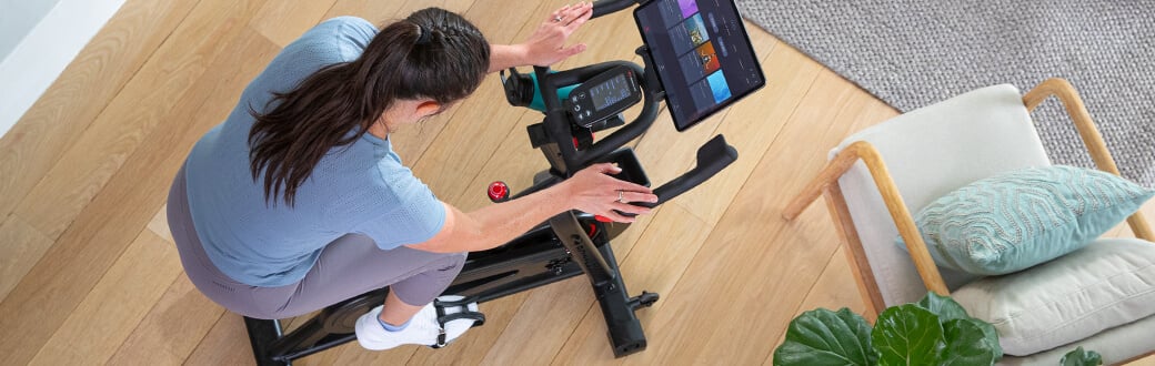 A woman using a VeloCore indoor cycling bike.