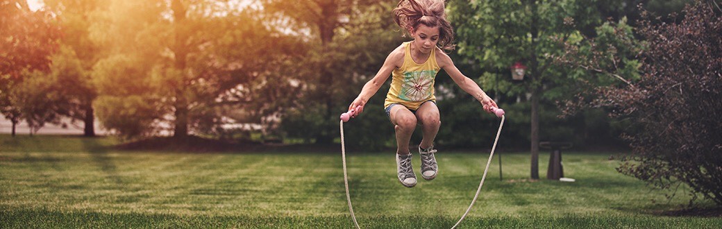 Child jumping rope outside