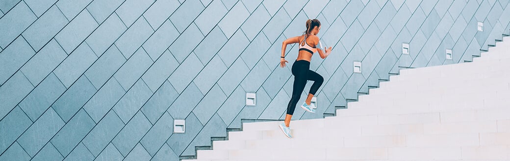 A woman running up stairs.