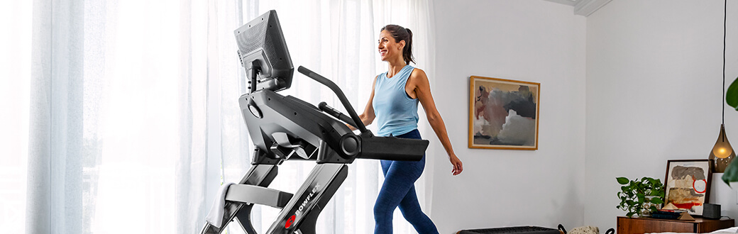 A woman using a Bowflex treadmill.