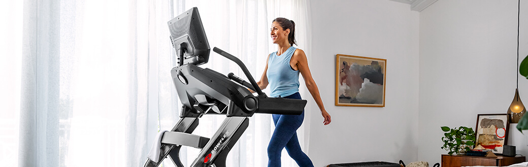 A woman using a BowFlex treadmill.