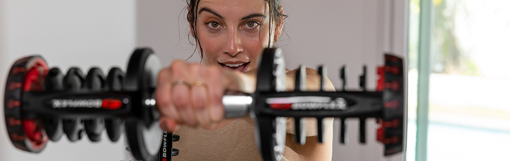 smiling woman with a dumbbell