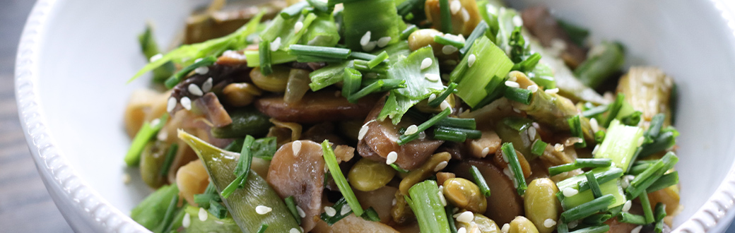 Mushroom, Asparagus, Snap Pea and Edamame Stir Fry in a serving dish.