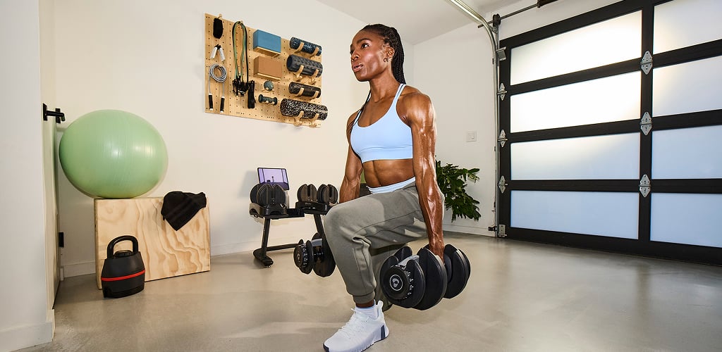 woman using bowflex selecttech dumbbells