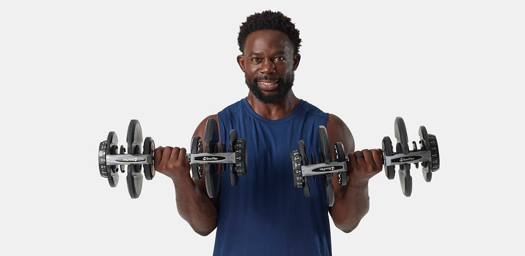 man using selettech dumbbells