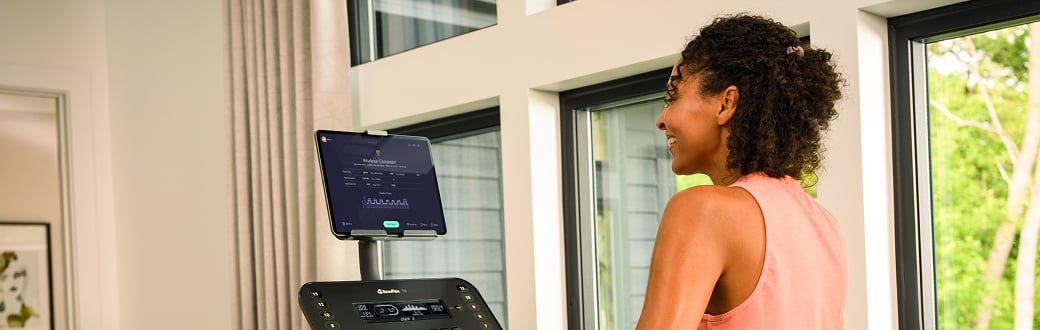woman looking at a treadmill screen