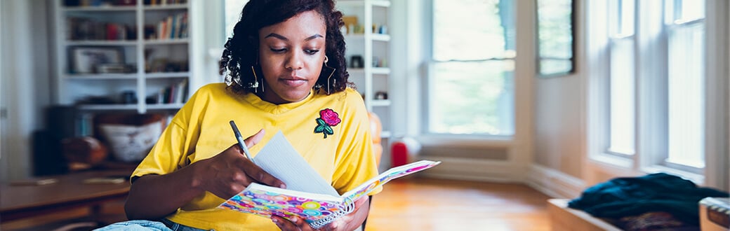 A woman writing down goals.